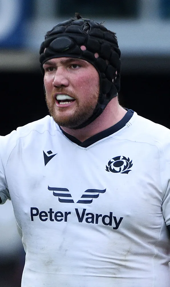 Scotland international rugby player wearing a headguard and mouthguard whilst playing away from home.