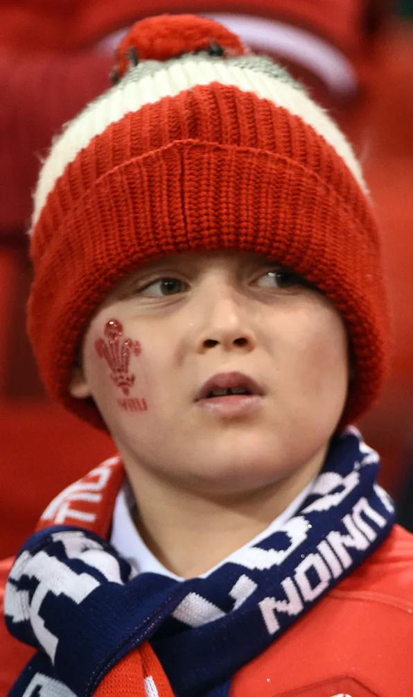 Kids Hats, Gloves & Scarfs A young Wales supporter wearing a beanie hat in his teams colours