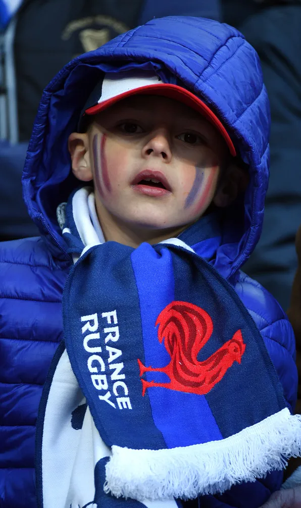 Kids Jackets, Fleeces & Gilets A young France supporter looks over his team wearing his teams colours