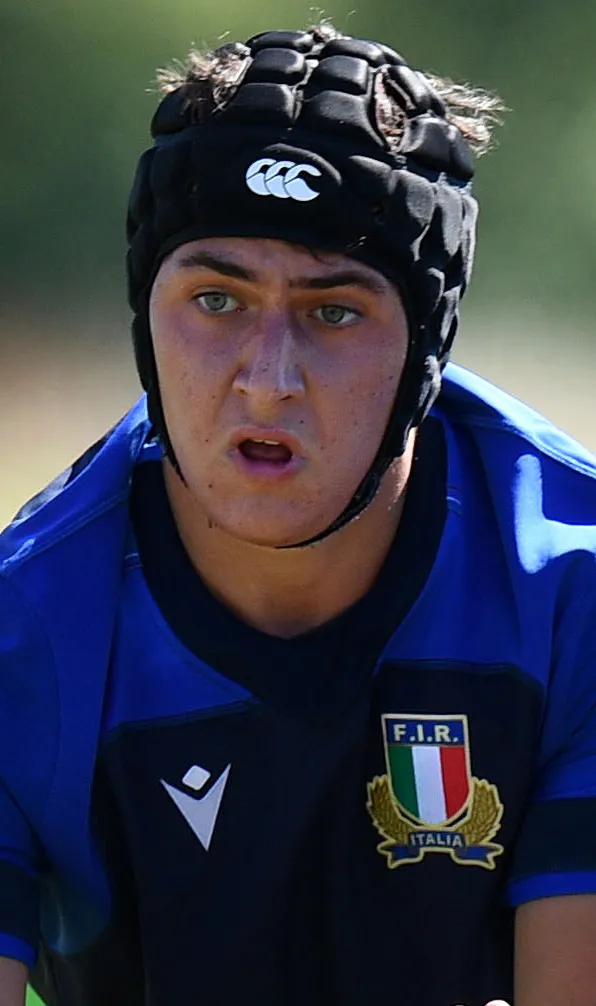 Kids Rugby Protective Wear A young Italy rugby player wearing a Canterbury scrum cap