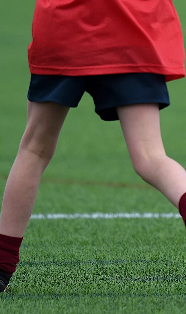 Kids Rugby Shorts A young rugby player sunning across the pitch wearing rugby shorts