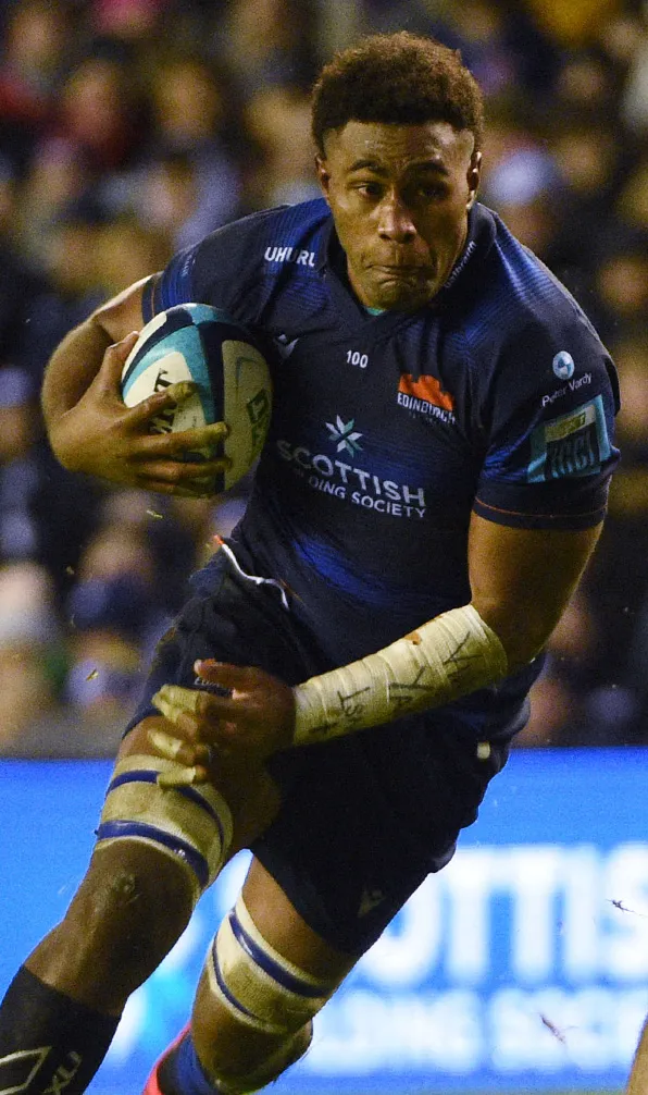 Edinburgh Rugby Edinburgh rugby player braces for impact while holding the ball