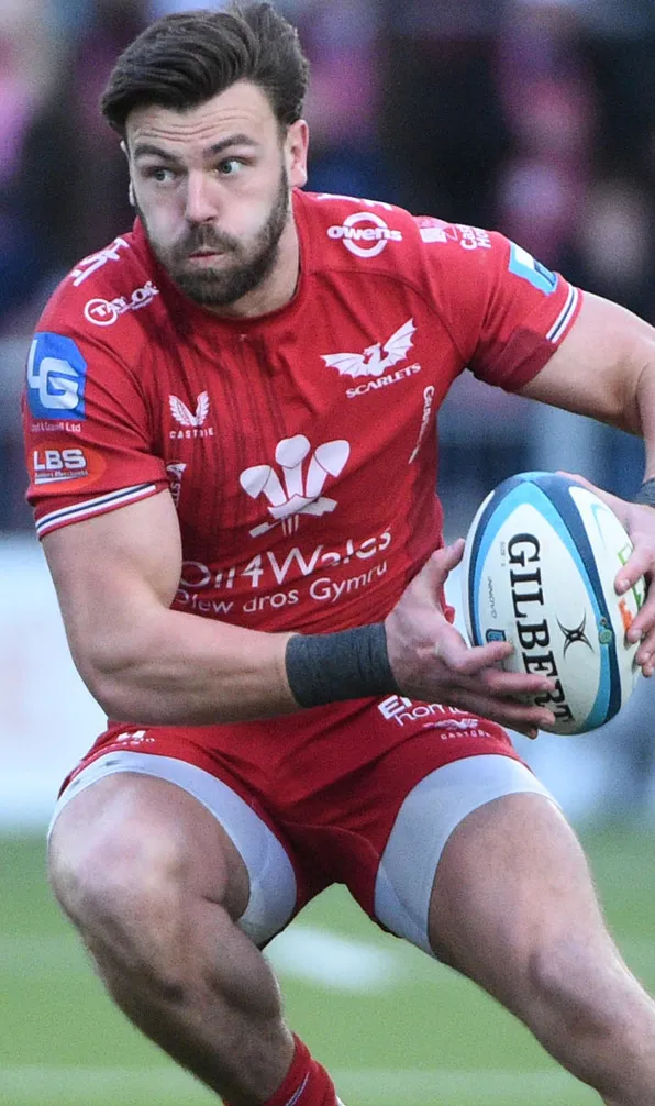 Scarlets Rugby A determined Scarlets rugby player quickly changing direction wearing the famous red kit