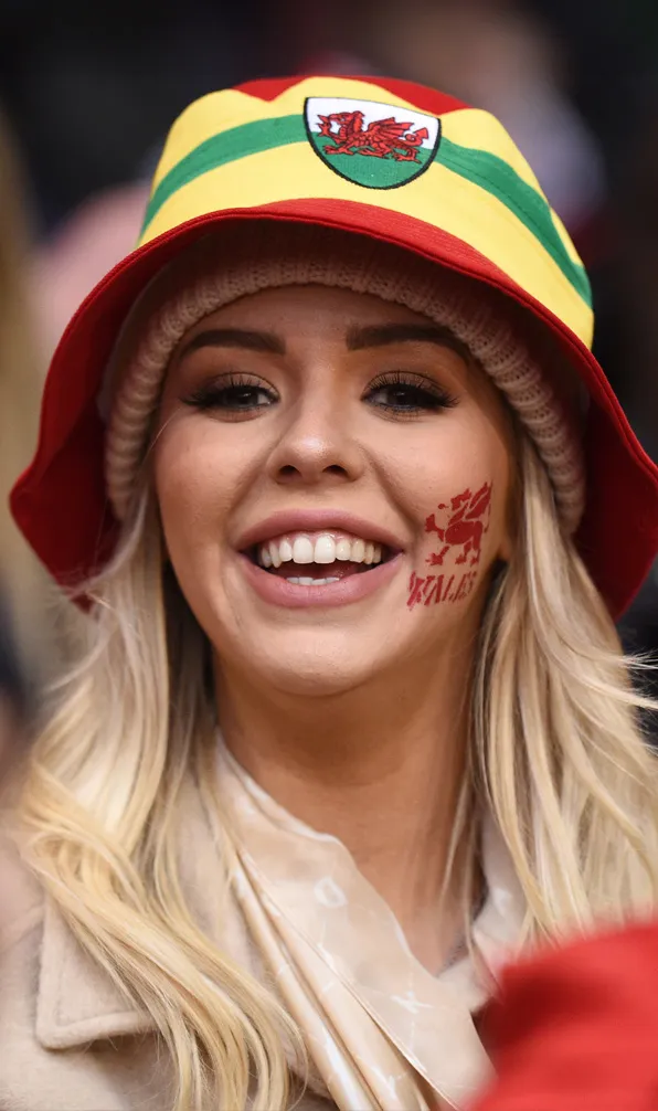 Womens Hats, Scarves & Gloves Welsh female supporter looking happy with her Wales hat on
