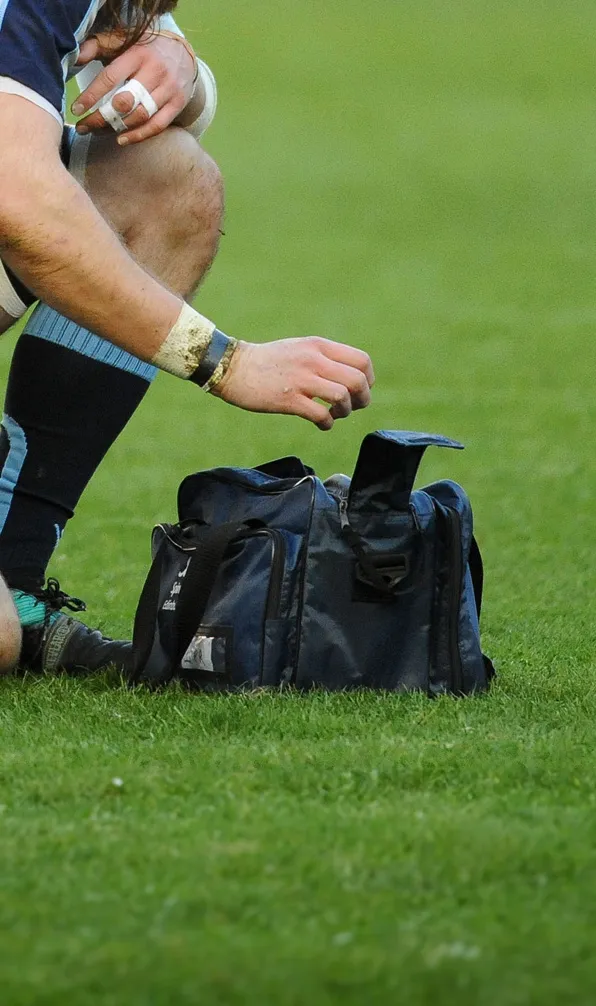 First Aid, Taping & Strapping Rugby player with taped fingers using a medical bag