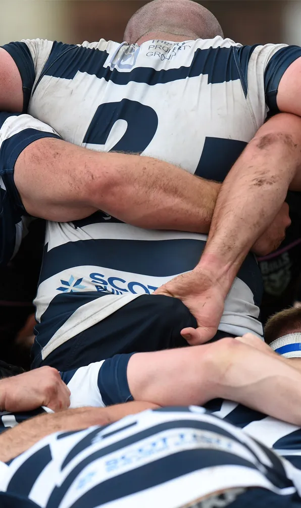 Teamwear Rugby Shirts Rugby team players grip they're navy and white striped shirts ready to engage for a scrum