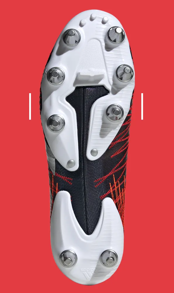 Standard Fit Rugby Boots Sole plate of some standard fit Adidas rugby boots on a red background