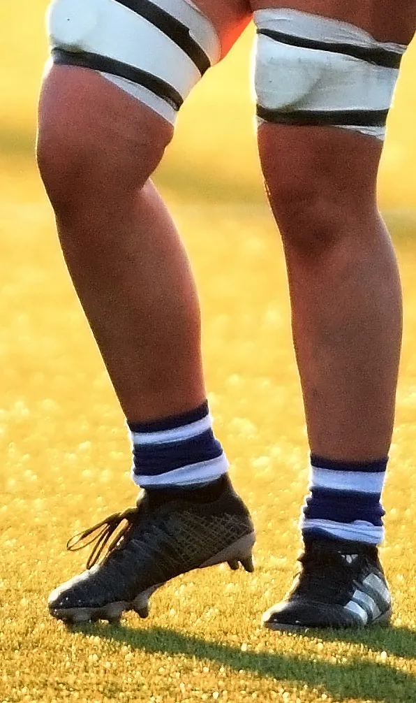 Womens Rugby Boots Female rugby player showing her Adidas rugby boots on pitch