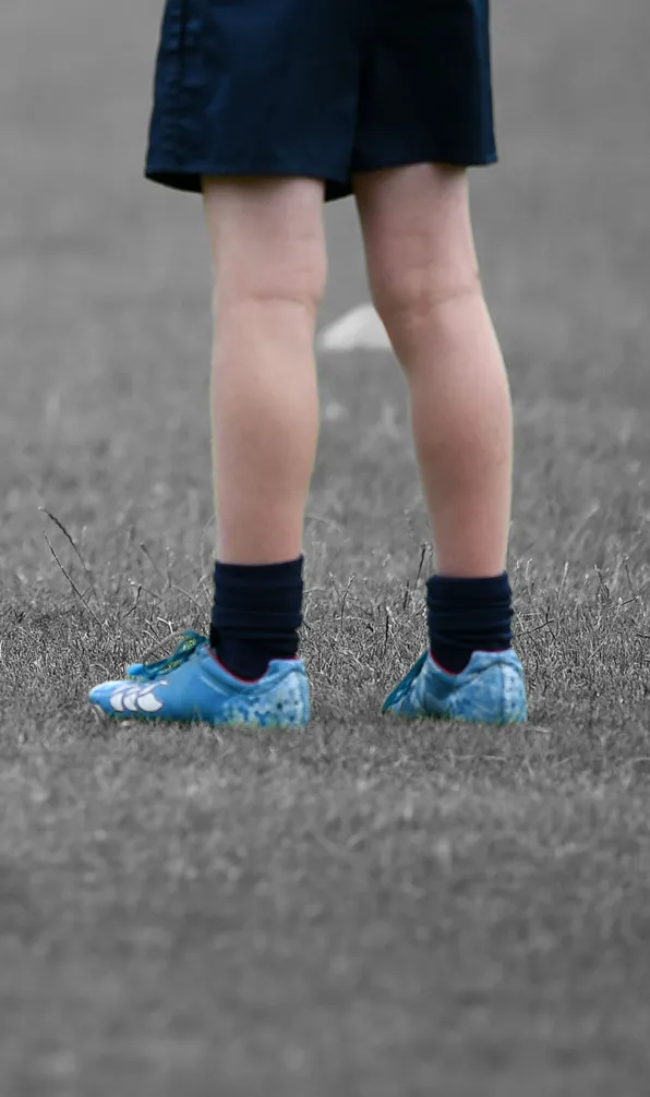Shop All Kids Boots Now Close up of young rugby player wearing blue boots