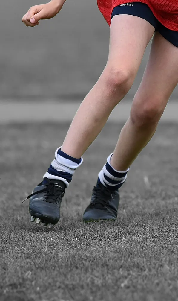 Shop Kids Club Boots Now Closeup of young rugby player running wearing black boots