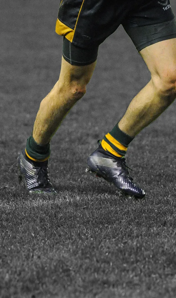 Shop Kids Elite Boots Now Young rugby player wearing black boots running