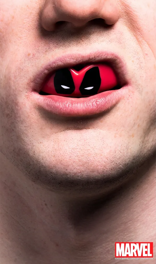 Shop Marvel Mouthguards Now Close up image of man wearing Deadpool themed mouthguard