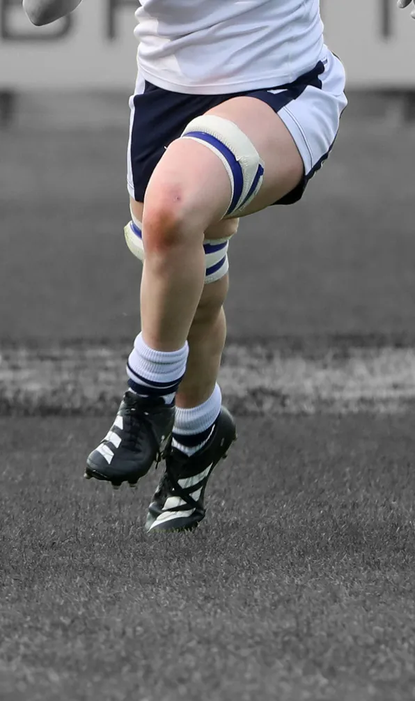 Shop Advanced Rugby Boots Now Close up of female rugby player wearing Black Adidas Boots