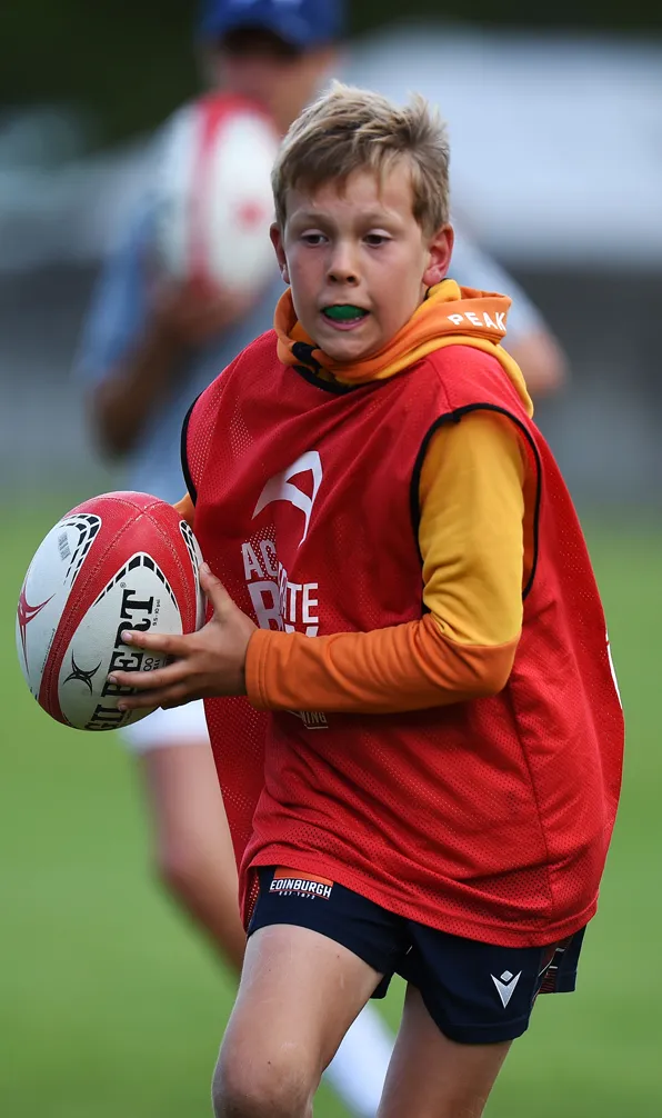 Shop Kids Gifts Now Child Rugby player runs with the ball as he tries to score a try at a training camp