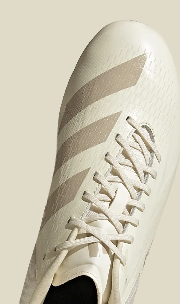Top view of an Adidas boot on an off-white background