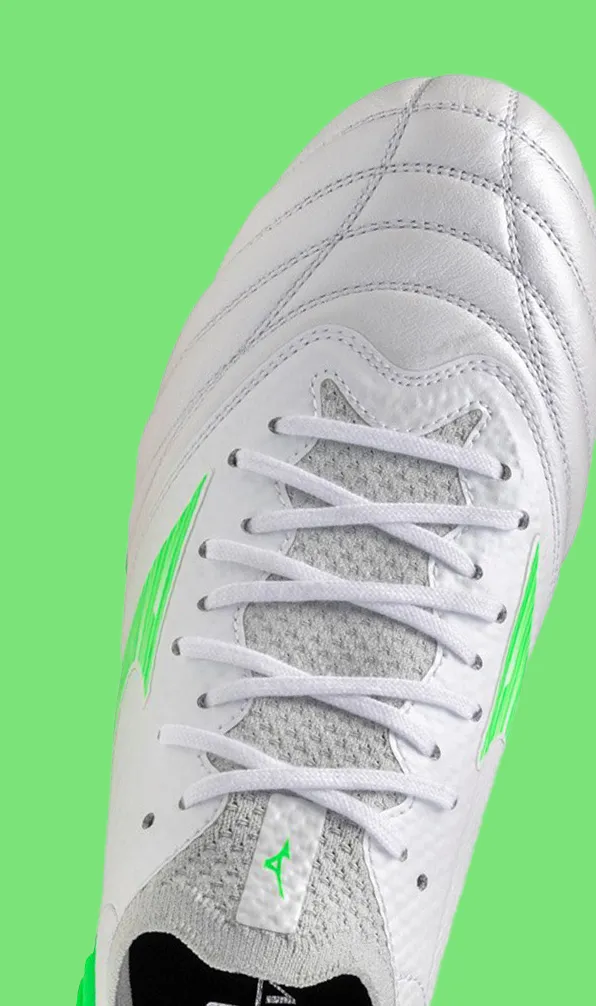 Top view of a Mizuno boot on a green background