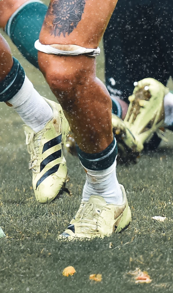 A close up image of the feet of a rugby player wearing Adidas rugby boots.
