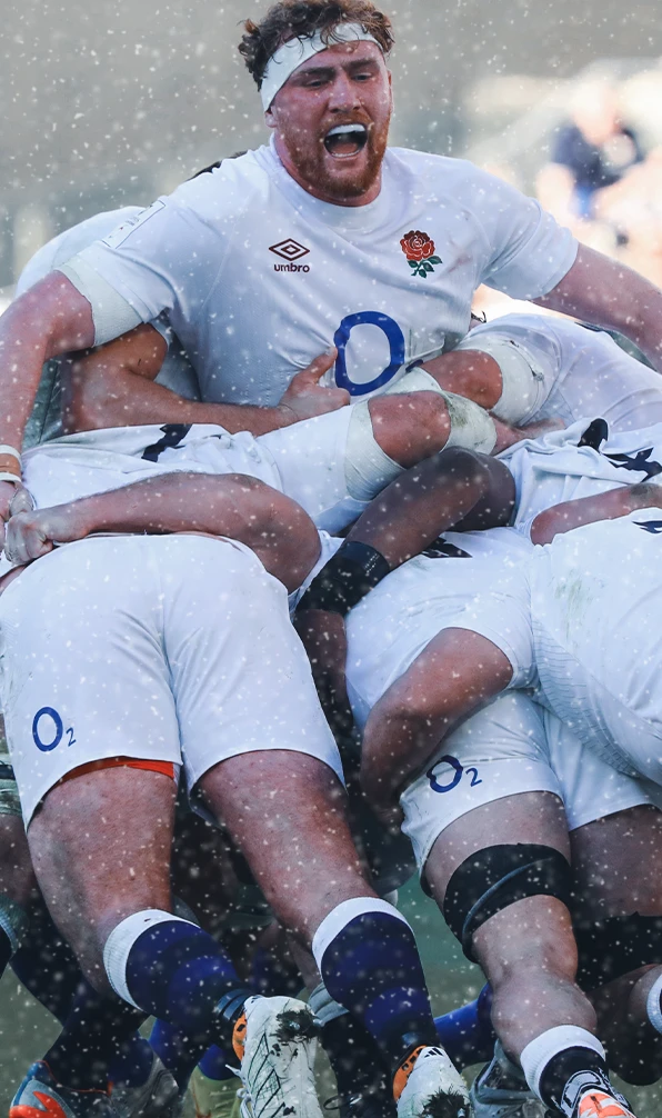 England player Ollie Chessum stands out the top of a rugby scrum as the rest of the forward push the scrum.