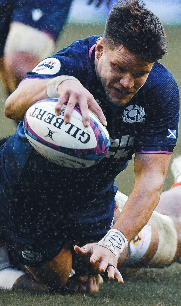 Scotland rugby player George Turner reaches for the try line to score a try.