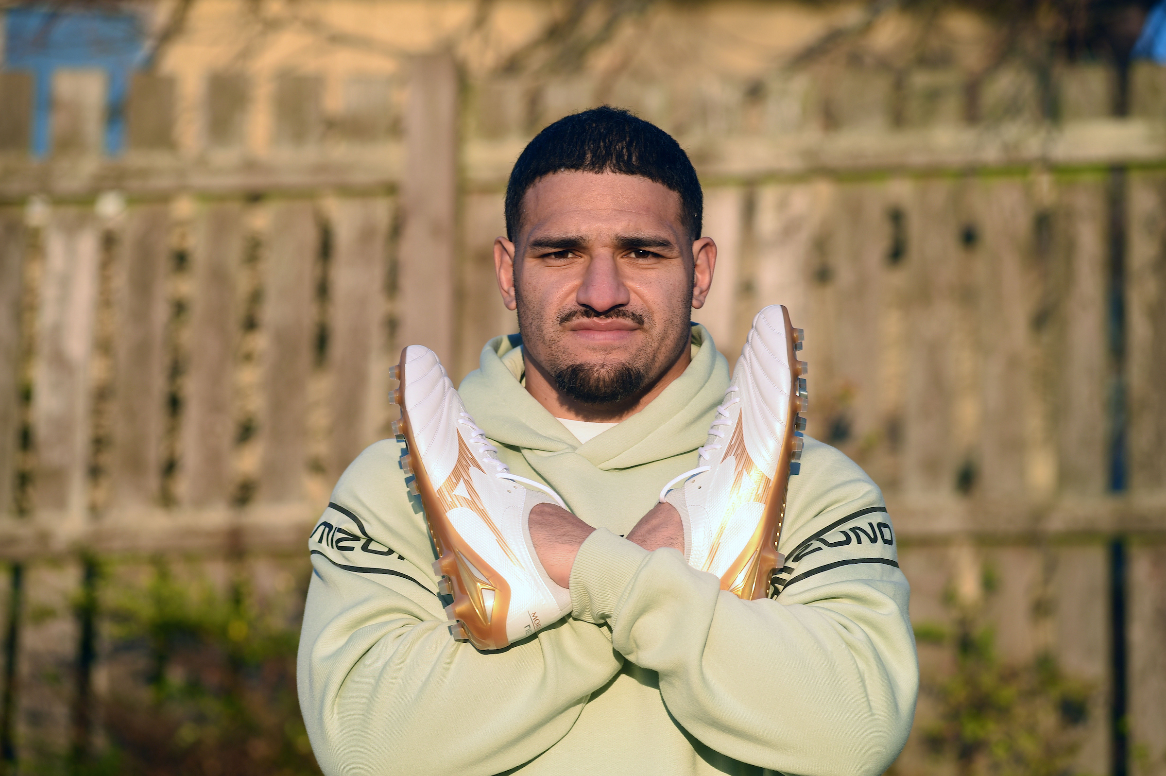 Mizuno Bright Gold Pack Sione Tuipulotu sitting as he promotes there Mizuno Bright Gold Pack