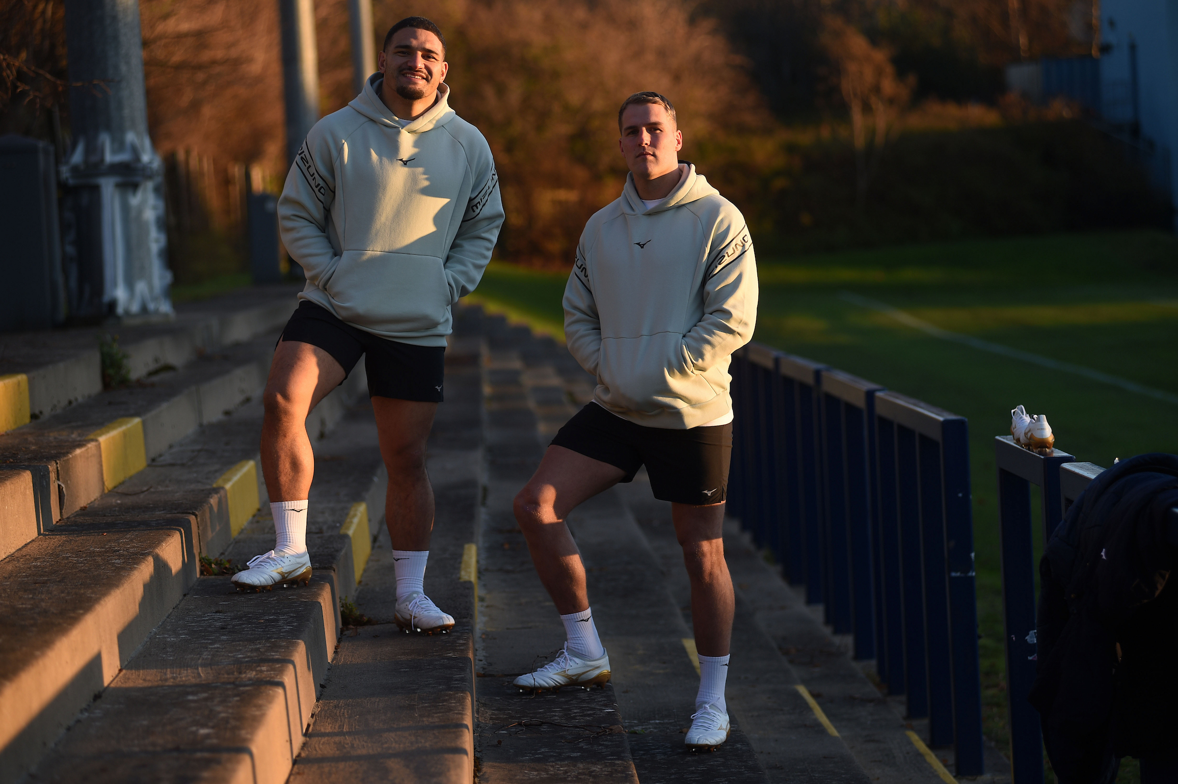 Tuipulotu and Van der Merwe Mizuno Bright Gold Pack Sione Tuipulotu and Duhan Van der Merwe stand together promoting the Mizuno Bright Gold Pack
