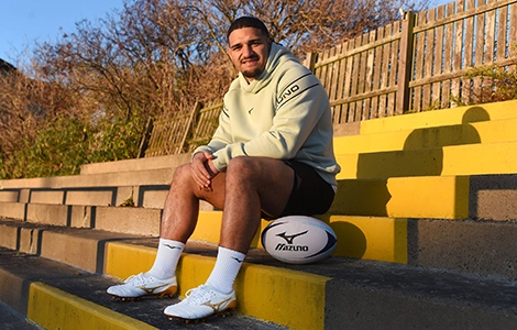 Sione Tuipulotu sitting as he promotes there Mizuno Bright Gold Pack