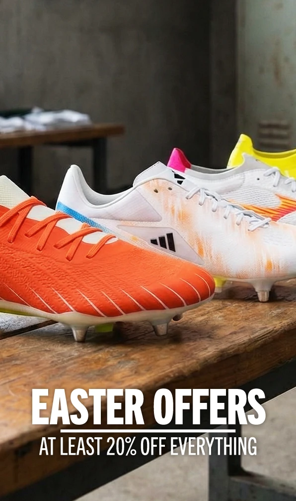 A close up image of a range of rugby boots sitting on a wooden bench.