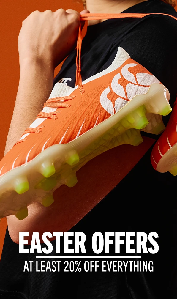 A close up image of Ellie Killdunne, Canterbury ambassador, carrying a pair of orange Canterbury rugby boots over her shoulder