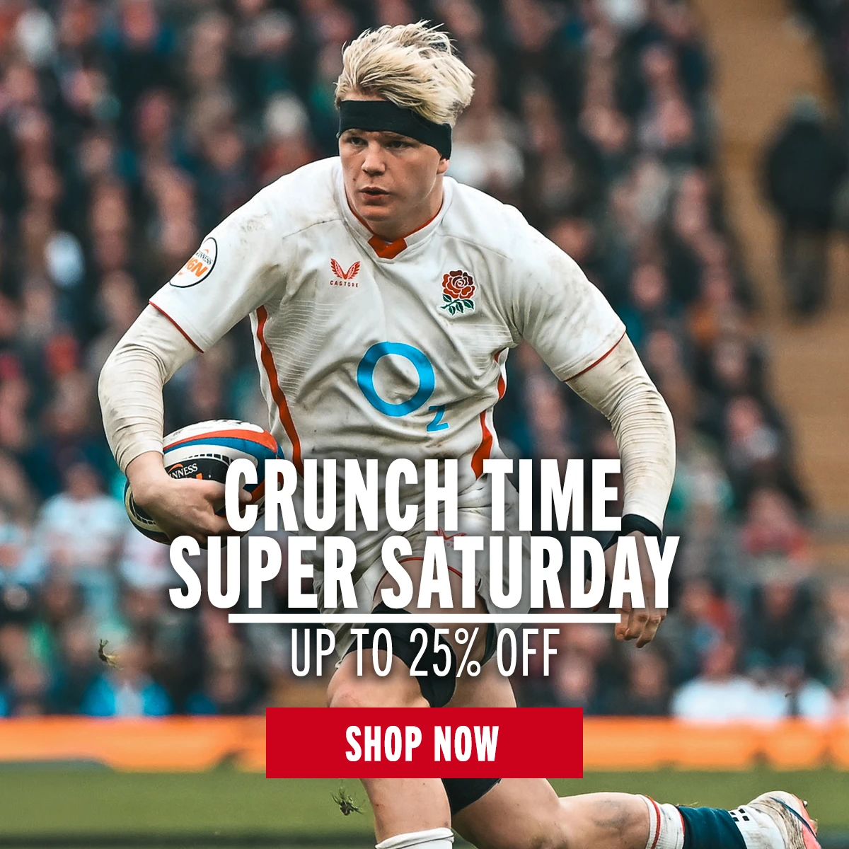 England rugby player Henry Pollock runs holding a rugby ball in his left hand. He is on a rugby pitch in front a large crowd of supporters