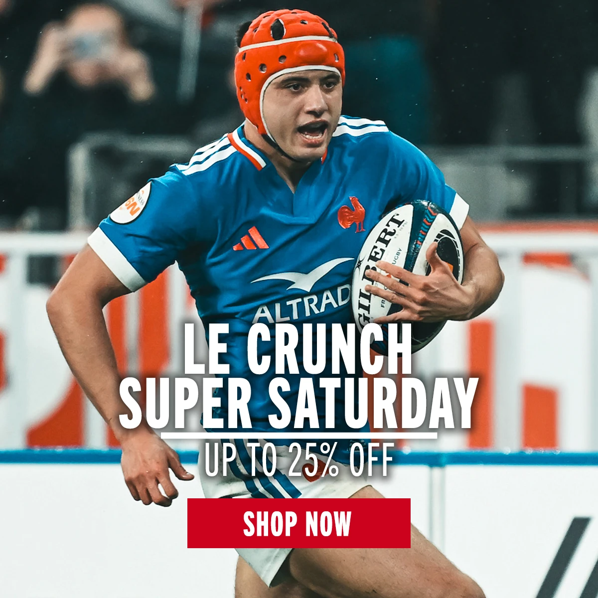 France rugby player Louis Bielle Biarrey runs with a rugby ball under his arm. He wears a red scuff cap headguard