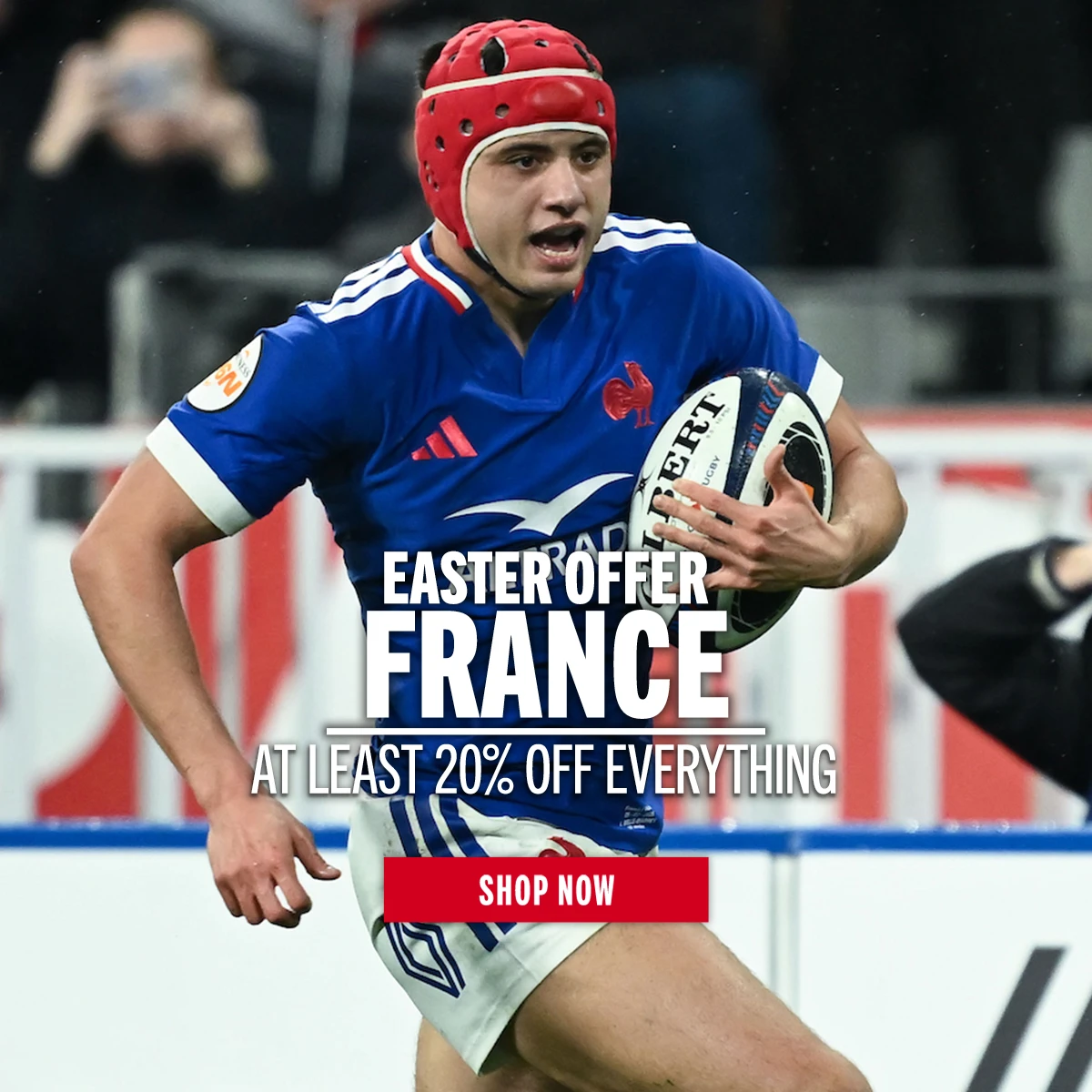 Shop France Easter Offers France rugby player Louis Bielle Biarrey runs with a rugby ball under his arm. He wears a red scuff cap headguard.