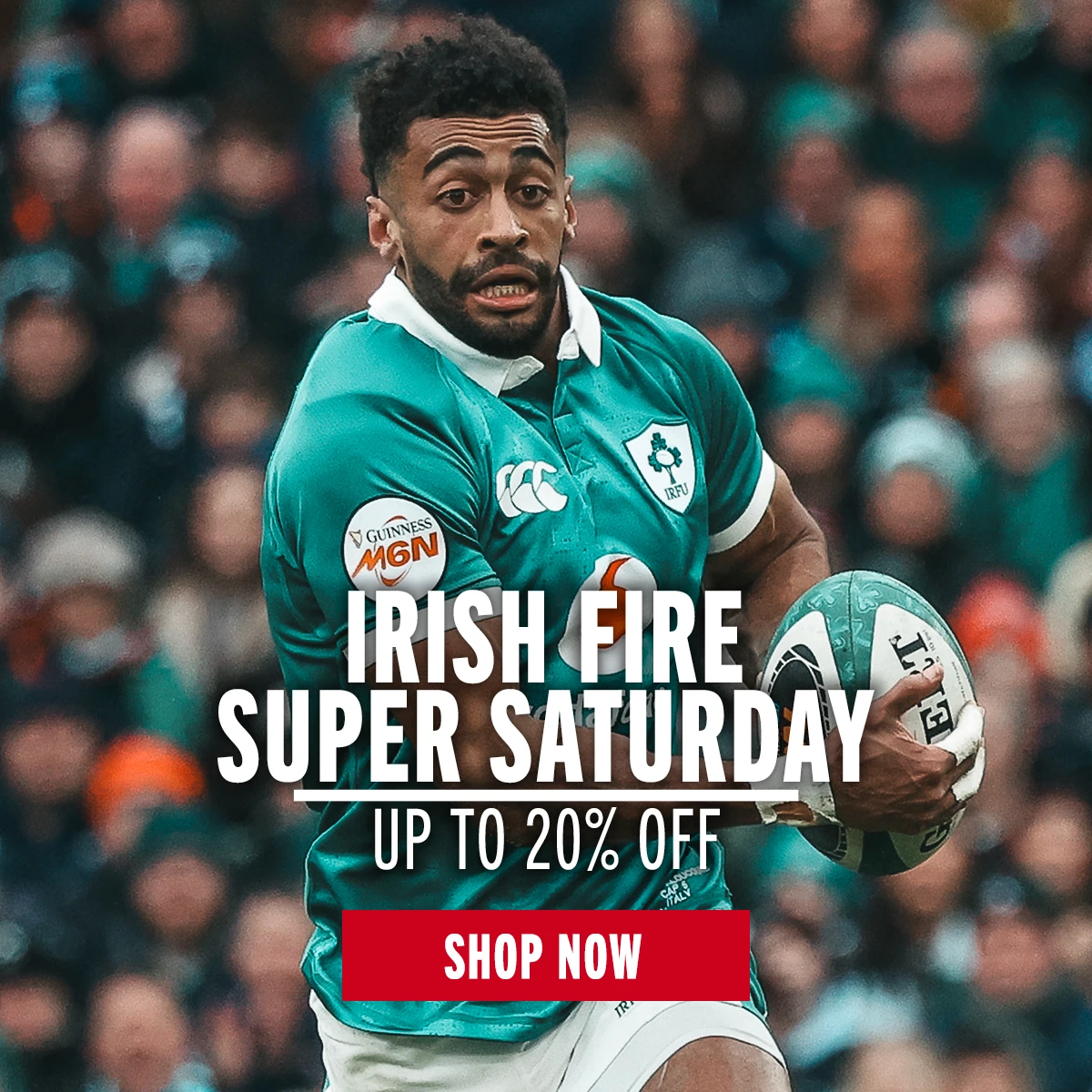 Ireland rugby player Robert Baloucoune runs with a rugby ball in front of a large crowd of supporters