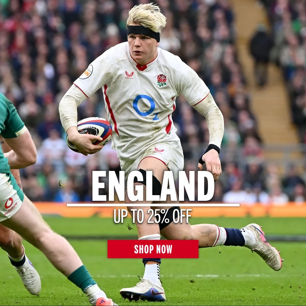 England rugby player Henry Pollock runs holding a rugby ball in his left hand. He is on a rugby pitch in front a large crowd of supporters
