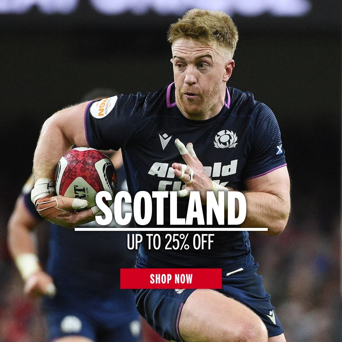 Scotland rugby player Kyle Stein runs with a rugby ball under his arm.