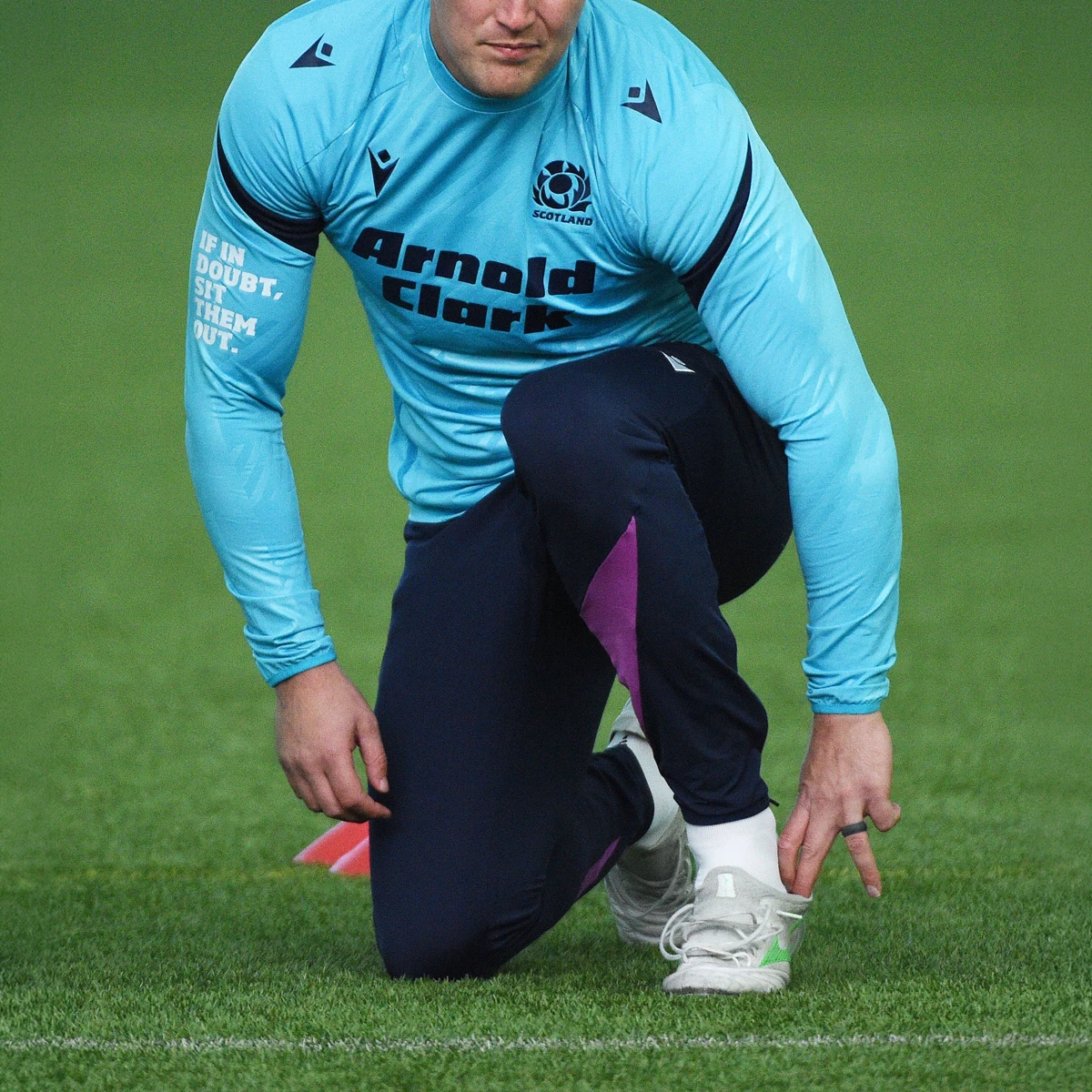 A Scotland rugby player gets ready for training as they put their Mizunoi boot on.