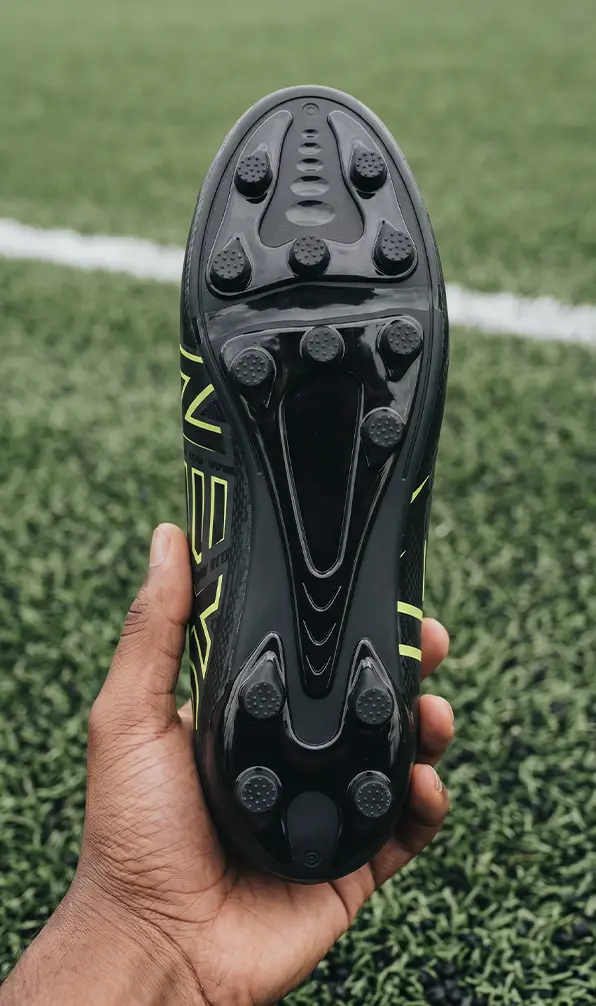 The soleplate of the Oxen Meta X All Ground rugby boot in someones had at 4G rugby pitch.