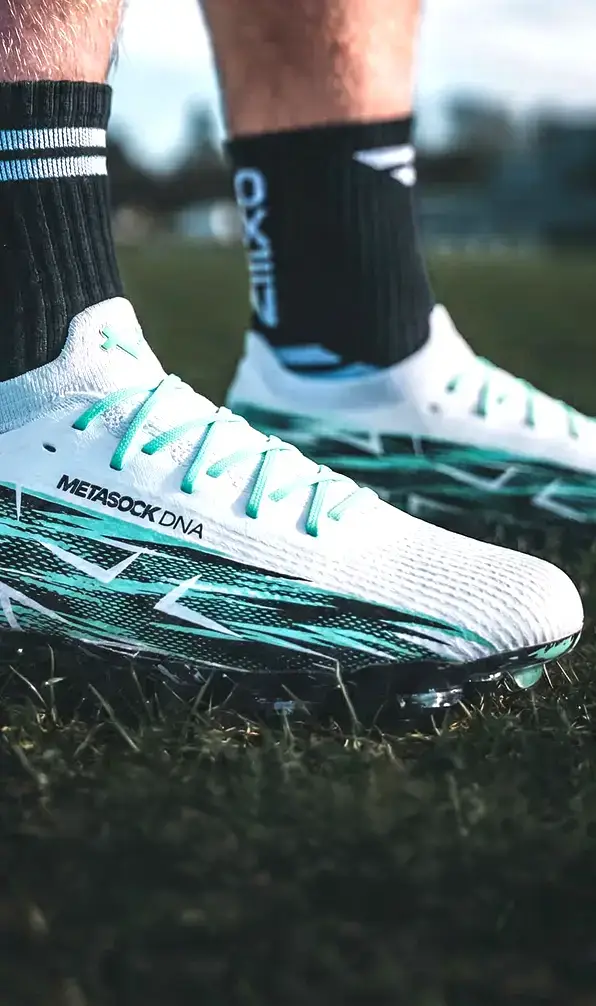 A close up image of a pair of Oxen Metasock rugby boots in white.