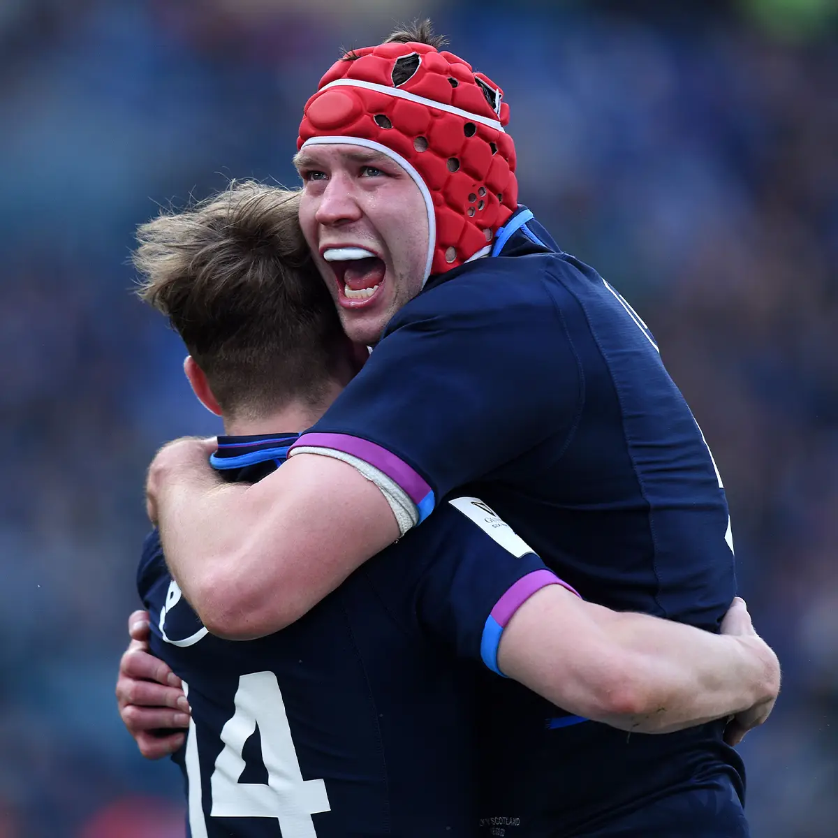 Rugby Headguards Grant Gilchrist celebrates with one of his teammates as Scotland claim victory.