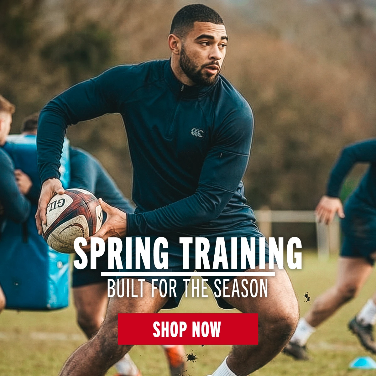 A rugby player dressed in Canterbury training clothing passes a rugby ball. The image has lots of motion.