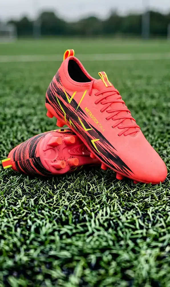 A close up of the new Oxen Meta X All Ground rugby boots in Orange Blaze.