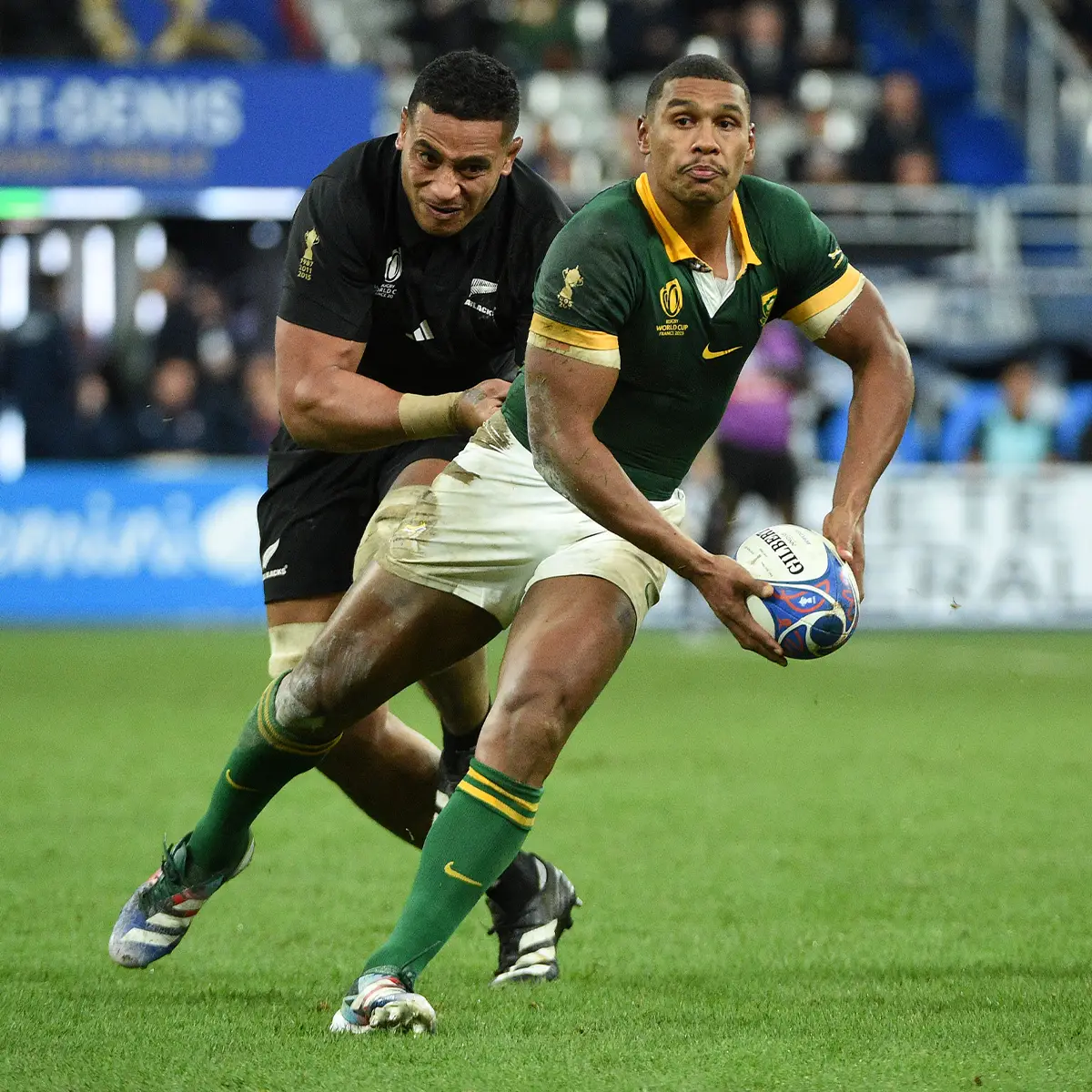 Damian Willemse of South Africa full back gets his pass away despite the tackle of Shannon Frizell