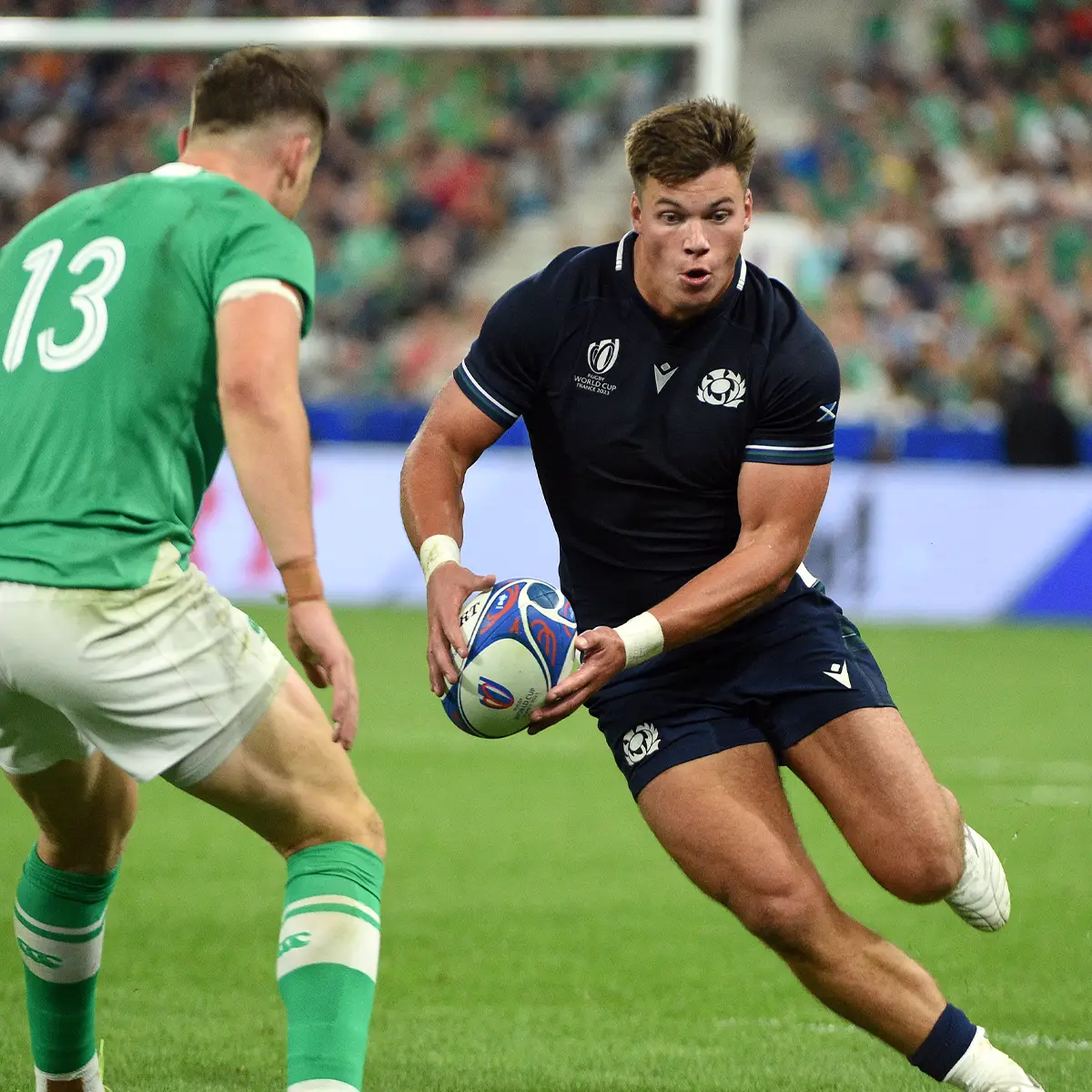 Scotland Centre, Huw Jones takes on Ireland's Garry Ringrose in Paris during the 2023 Rugby World Cup Pool Stages