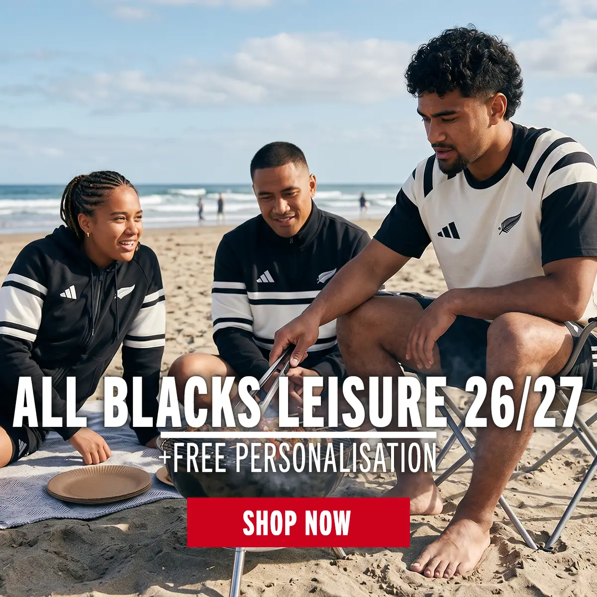 Three people are chilling on a beach wearing the new All Blacks Leisure as they enjoy the heat.
