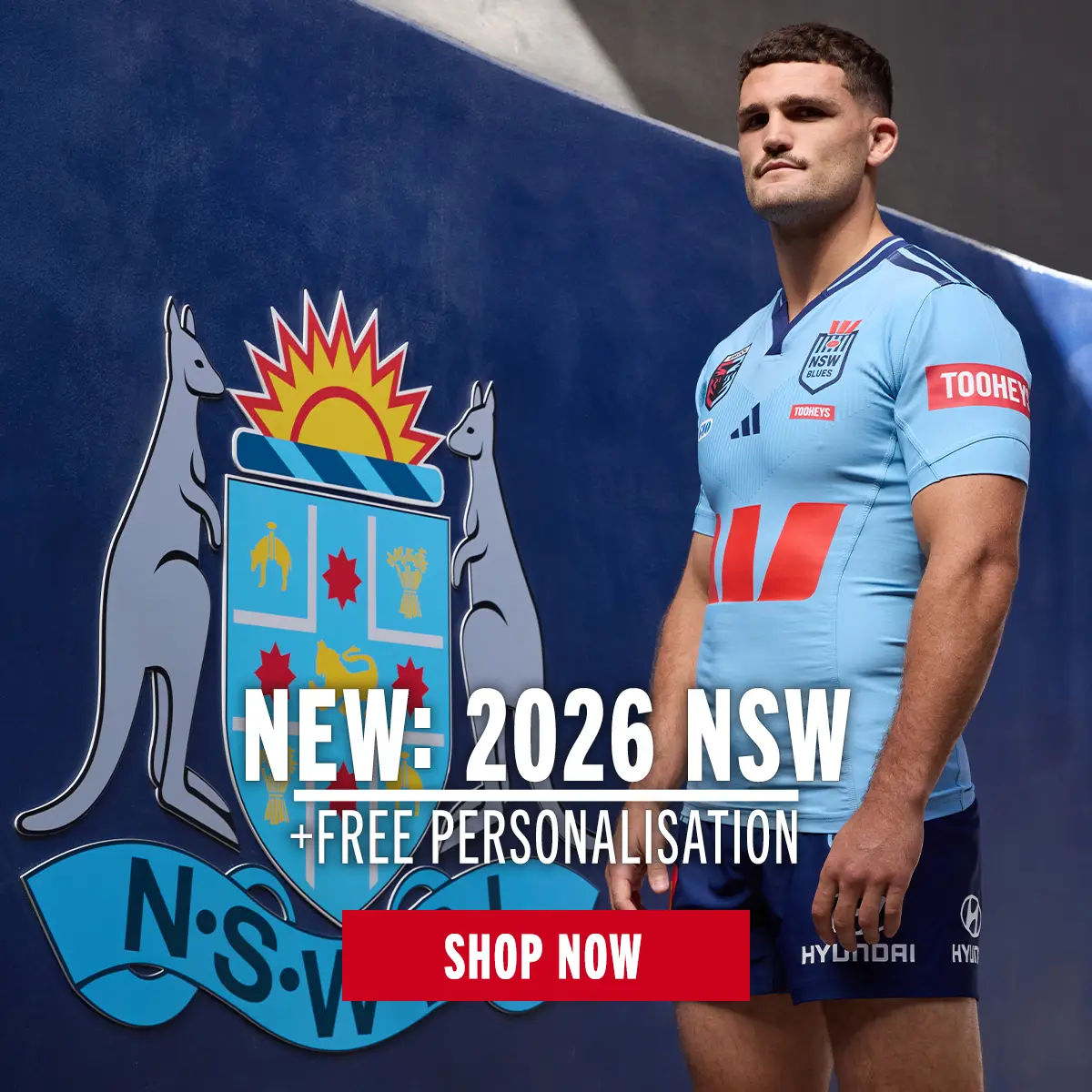 A New South Wales player stands next to the NSW crest while wearing the latest kit.