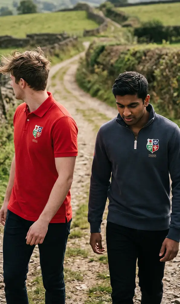 Two guys walking through the countryside in Rugbystore's Lions1888 classic rugby clothing.