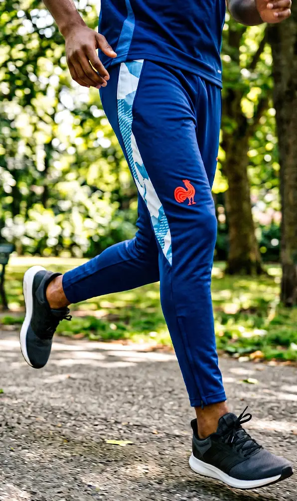 A man is running through a park in a pair of France pants.
