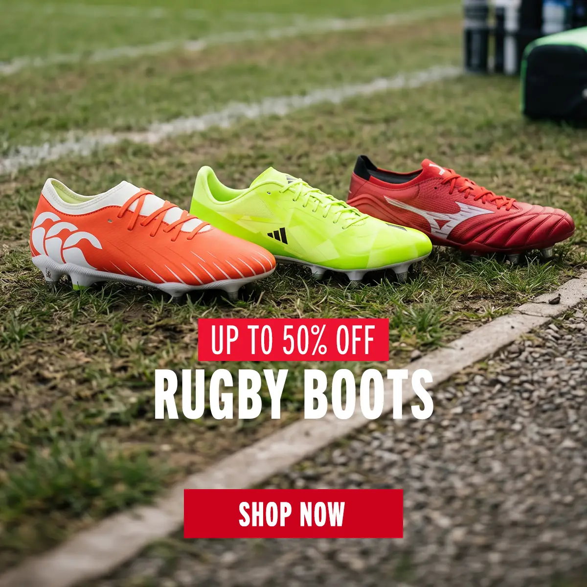 Three boots from Canterbury, Adidas and Mizuno sit on the sideline of a rugby pitch.