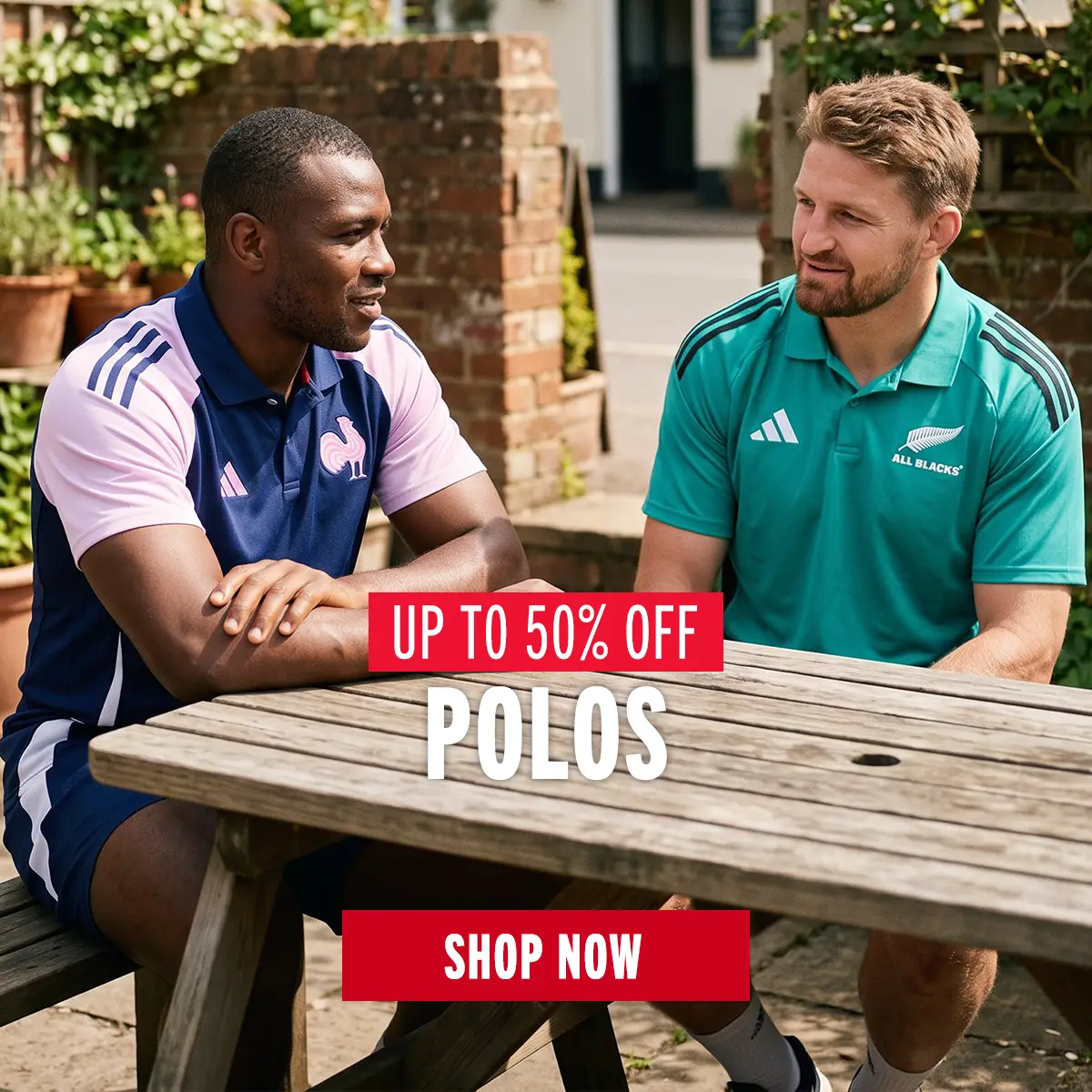 Two guys are sitting at in a beer garden wearing their France and All Blacks Polos.