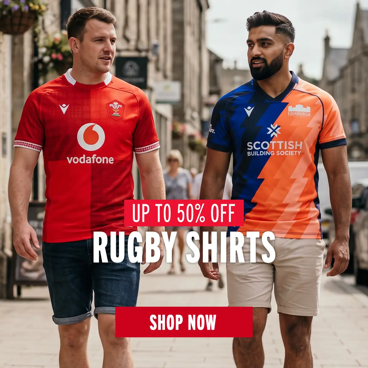 Two guys walking through town as they wear the Wales and Edinburgh rugby shirts.
