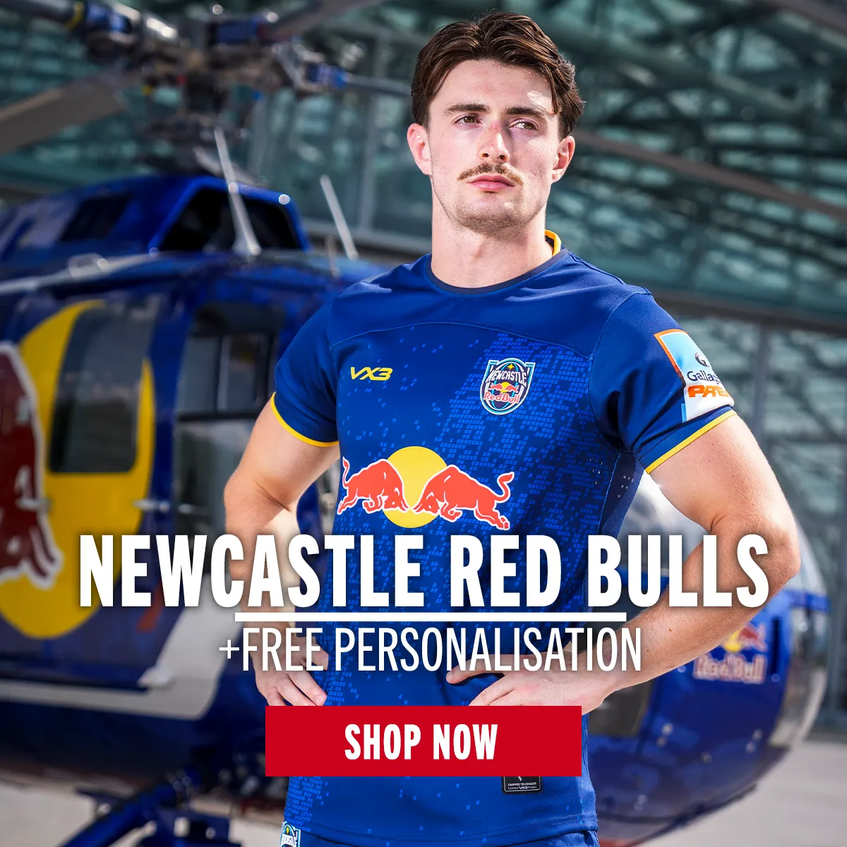 Newcastle Red Bulls 26/27 A Newcastle Red Bulls player stands in the new 26/27 home kit, as a Red Bull helicopter is parked behind him.